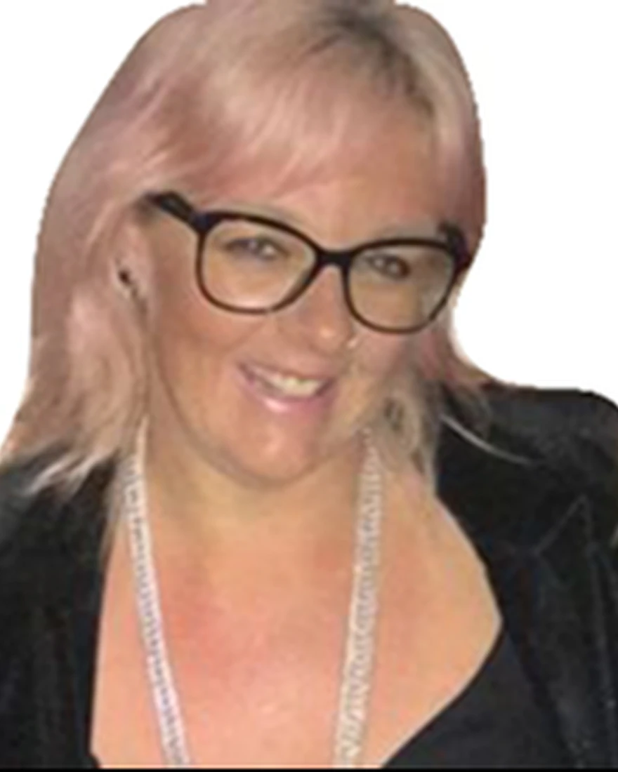 A woman with pink hair and glasses smiles at the camera, representing Nicole Talarico's expertise in early childhood.